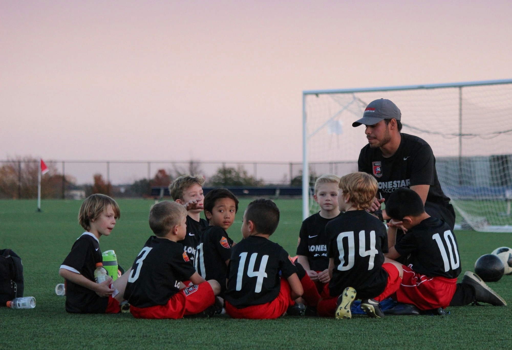 Student athlete coaching young soccer players